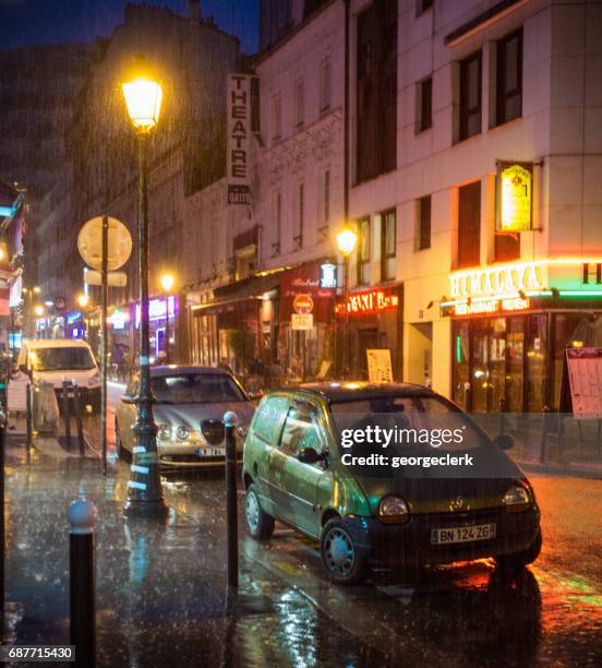 torrential rain on a paris street - montparnasse stock pictures, royalty-free photos & images