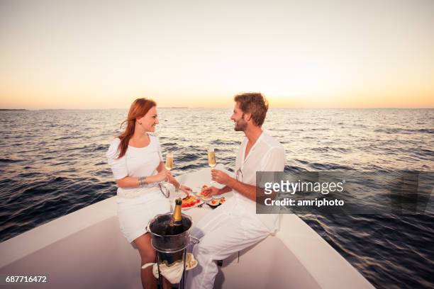 couple love sunset boat - romantic sky stock pictures, royalty-free photos & images