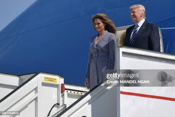 President Donald Trump and First Lady Melania Trump step off the Air Force One upon arrival at Melsbroek military airport in Steenokkerzee on May 24,...