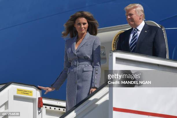 President Donald Trump and First Lady Melania Trump step off the Air Force One upon arrival at Melsbroek military airport in Steenokkerzee on May 24,...