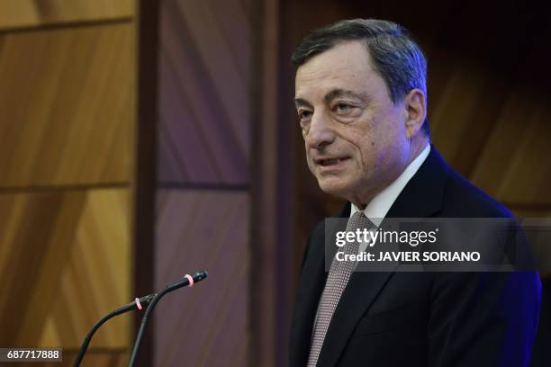 Italian President of the European Central Bank Mario Draghi speaks during a conference in Madrid on May 24, 2017. Spanish Chairman of the Spanish...