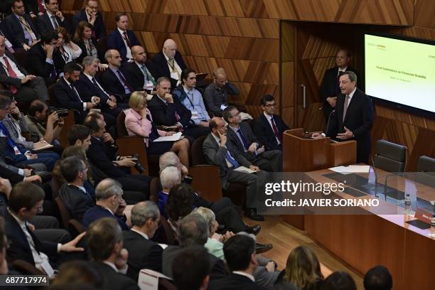 Italian President of the European Central Bank Mario Draghi speaks during a conference in Madrid on May 24, 2017. Spanish Chairman of the Spanish...