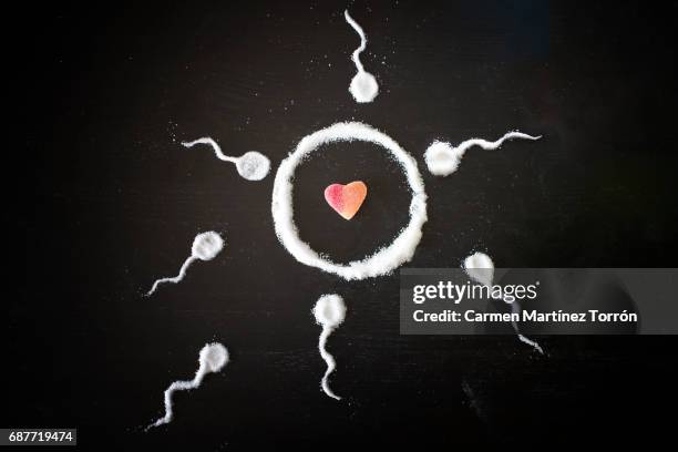 sperm cells about to fertilize an ovum and create some love - cholesterol test - fotografias e filmes do acervo