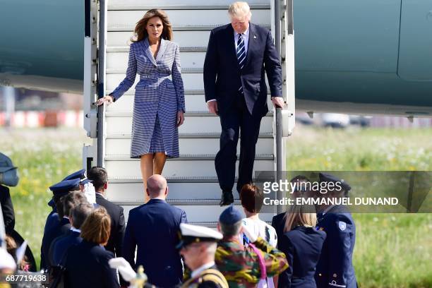 President Donald Trump and First Lady Melania Trump step off the Air Force One upon arrival at Melsbroek military airport in Steenokkerzeel on May...