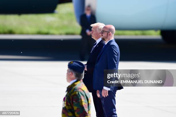 President Donald Trump stands next to Belgian Prime Minister Charles Michel upon arrival at Melsbroek military airport in Steenokkerzeel on May 24,...