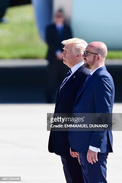 President Donald Trump stands next to Belgian Prime Minister Charles Michel upon arrival at Melsbroek military airport in Steenokkerzeel on May 24,...