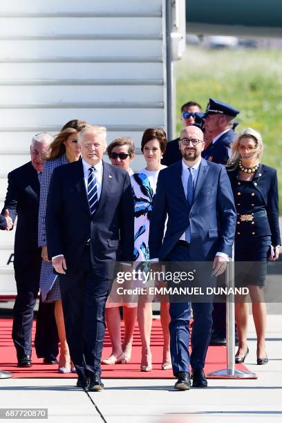 President Donald Trump walks with Belgian Prime Minister Charles Michel next to US First Lady Melania Trump and Amelie Derbaudrenghien, partner of...