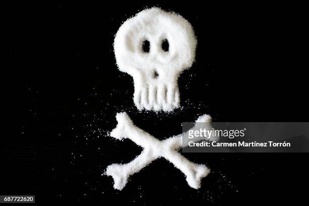 skull and crossbones made of sugar or salt - cholesterol test - fotografias e filmes do acervo