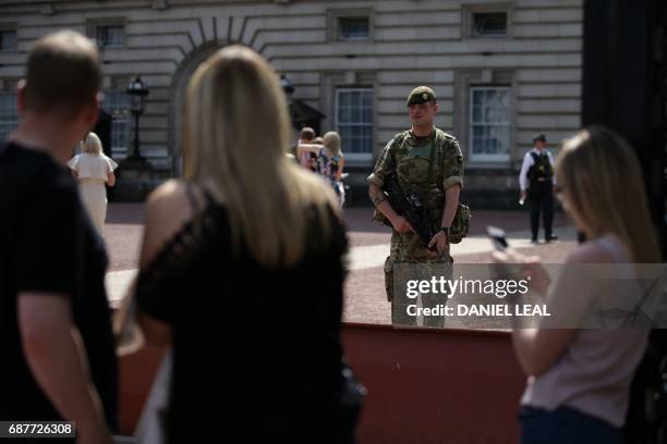 British Army soldier stands on duty at Buckingham Palace in central London on May 24, 2017. Britain deployed soldiers to key sites Wednesday and...