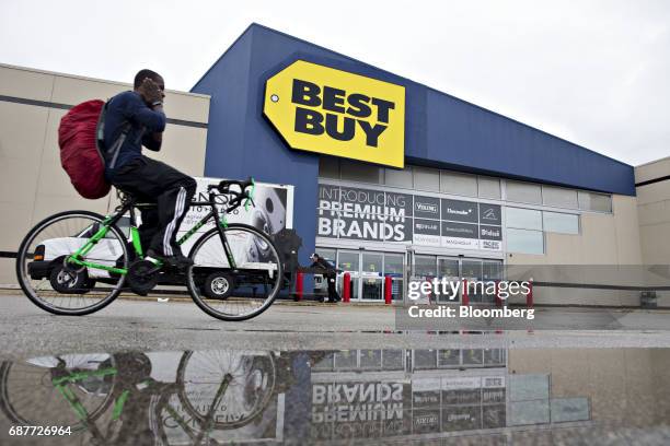 Cyclist passes in front of a Best Buy Co. Store in Downers Grove, Illinois, U.S., on Tuesday, May 23, 2017. Best Buy Co. Is scheduled to release...