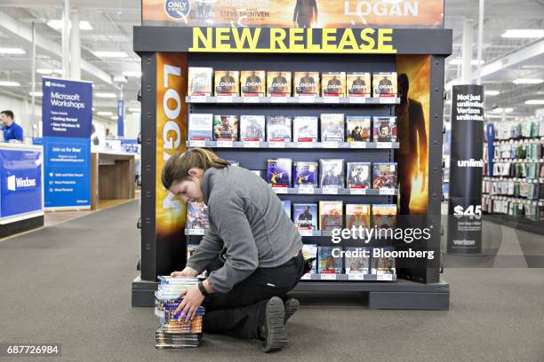 An employee stocks new release videos for sale at a Best Buy Co. Store in Downers Grove, Illinois, U.S., on Tuesday, May 23, 2017. Best Buy Co. Is...