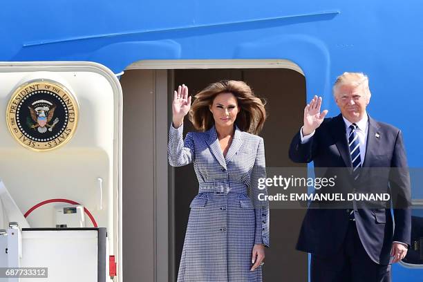 President Donald Trump and First Lady Melania Trump wave as they step off the Air Force One upon arrival at Melsbroek military airport in...