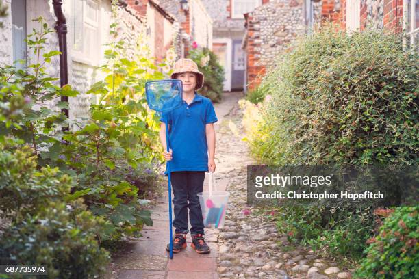 young boy standing outside holiday cottage - norfolk england stock pictures, royalty-free photos & images