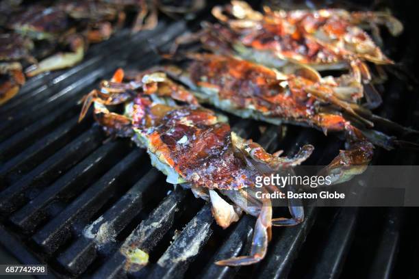 Soft shell crabs are pictured on the grill as Irene Li, chef and co-owner of Mei Mei Street Kitchen food truck and Mei Mei restaurant, prepares them...