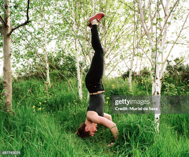 girl standing on head in nature - girl yoga upside down stock pictures, royalty-free photos & images