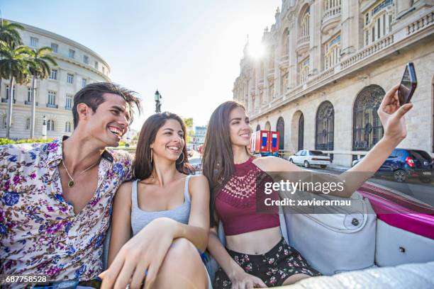young friends taking selfie in convertible car - havana stock pictures, royalty-free photos & images