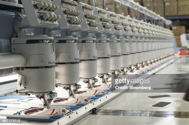 Embroidery machines stitch designs for hats at the Graffiti Caps production facility in Cleveland, Ohio, U.S., on Tuesday, May 9, 2017. The U.S....