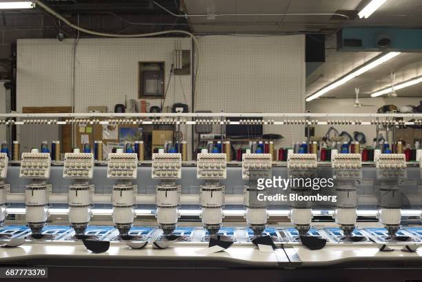 Embroidery machines stitch designs onto baseball hats at the Graffiti Caps production facility in Cleveland, Ohio, U.S., on Tuesday, May 9, 2017. The...