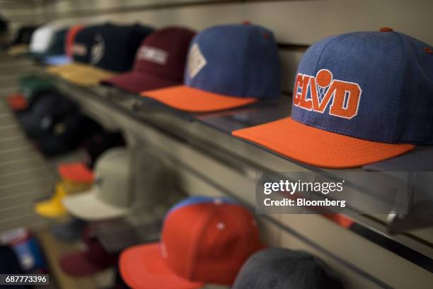 Finished baseball hats sit on shelves in the display area of the Graffiti Caps production facility in Cleveland, Ohio, U.S., on Tuesday, May 9, 2017....