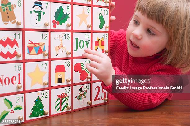 small girl with advent calendar - child with advent calendar stock pictures, royalty-free photos & images