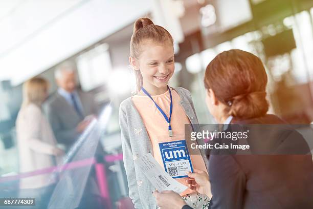 flight attendant talking to girl in airport - airport crew stock pictures, royalty-free photos & images