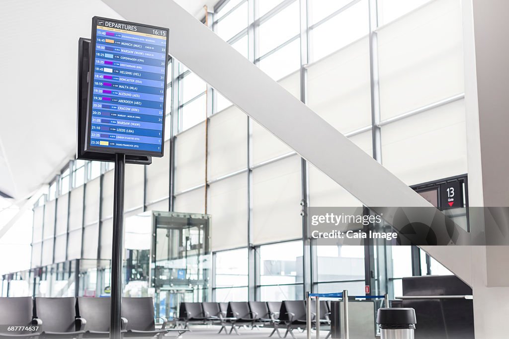 Arrival departure board in empty airport concourse