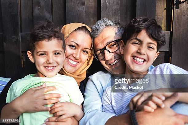 portrait of happy family outside house - muslim boy stockfoto's en -beelden