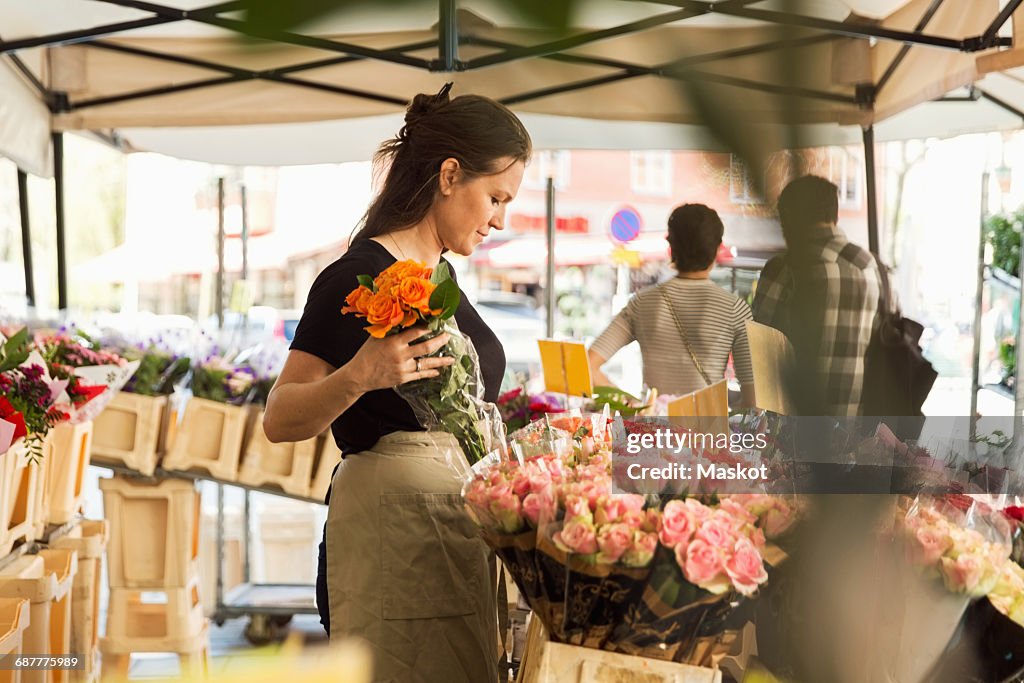 Side view of female owner working at flower shop