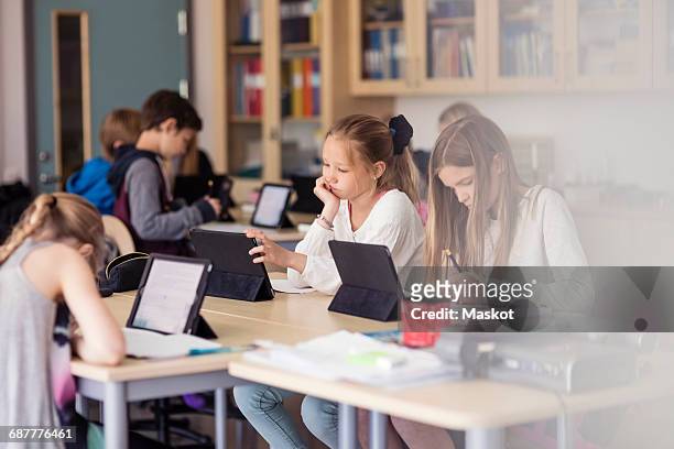 high school children using digital tablet in classroom - school tablet stockfoto's en -beelden