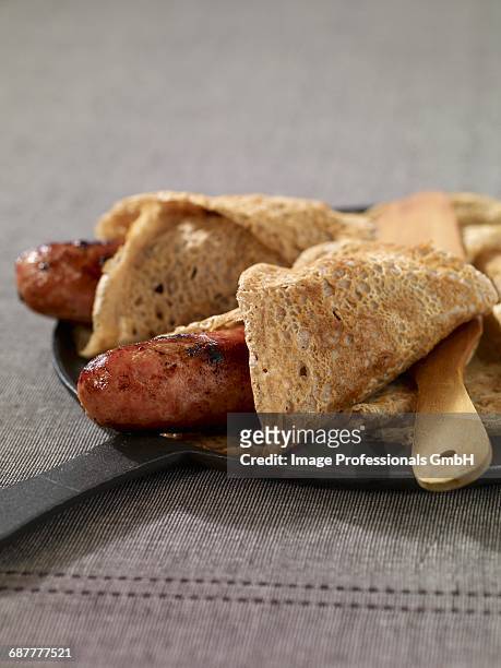 robiquette,sausage in a buckwheat crepe - biscotte stock-fotos und bilder