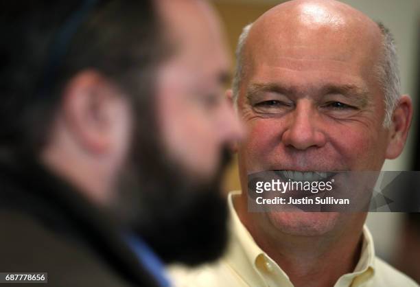 Republican congressional candidate Greg Gianforte talks with a supporter during a campaign meet and greet at Lambros Real Estate on May 24, 2017 in...