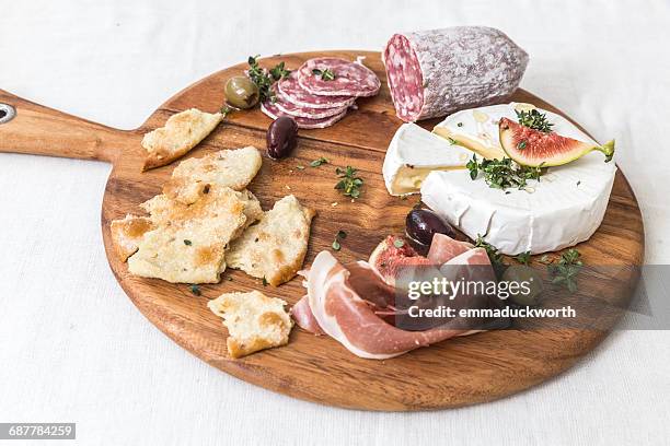 cheese and cured meats on chopping board - charcuterie board 個照片及圖片檔