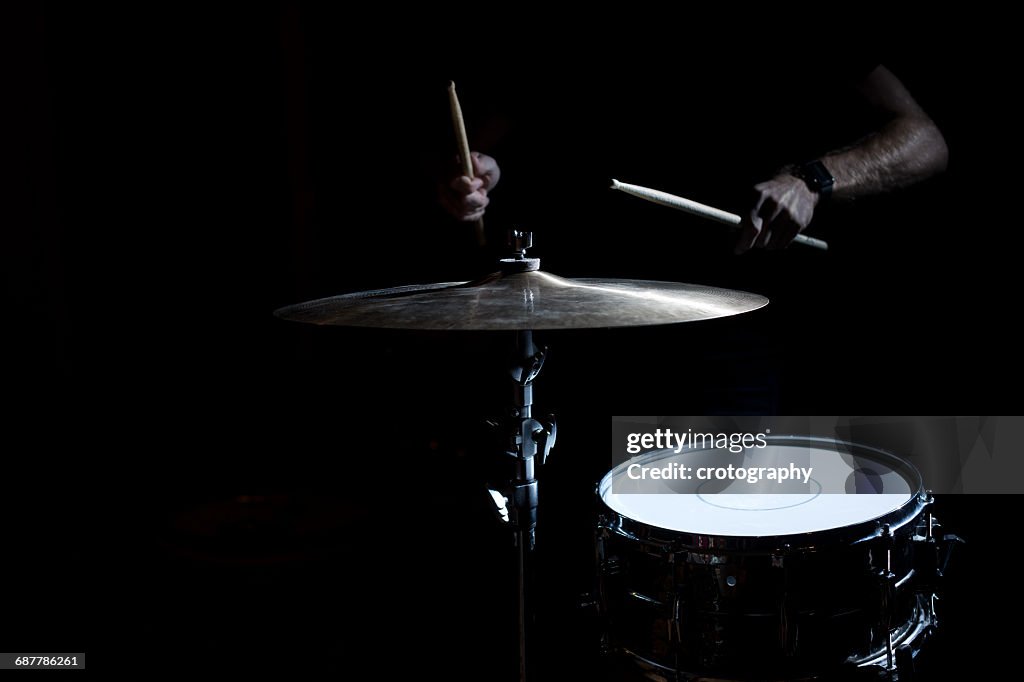 Man playing drums and cymbal