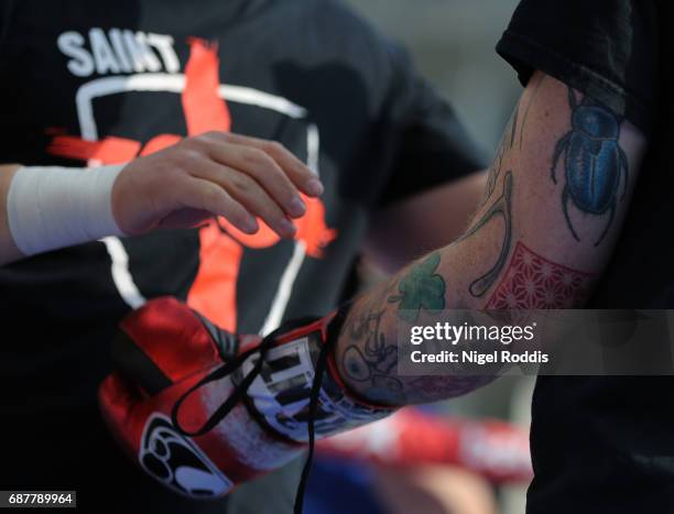 George Groves has his gloves tied during a public workout at the Peace Gardens on May 24, 2017 in Sheffield, England. Groves will fight Fedor...