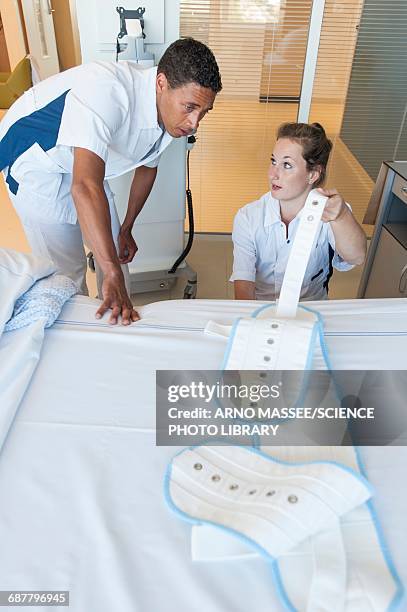 two nurses fastening medical restraint - belt imagens e fotografias de stock