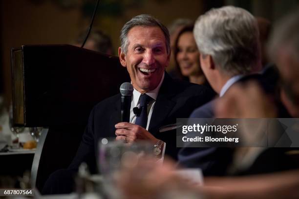 Howard Schultz, chairman and founder of Starbucks Corp., laughs during a conference at the Economic Club of New York in New York, U.S., on Wednesday,...