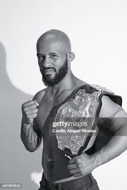 Portrait of UFC Flyweight champion Demetrious Johnson posing with belt during photo shoot at Time Inc. Studios. Johnson has succesfully defended his...