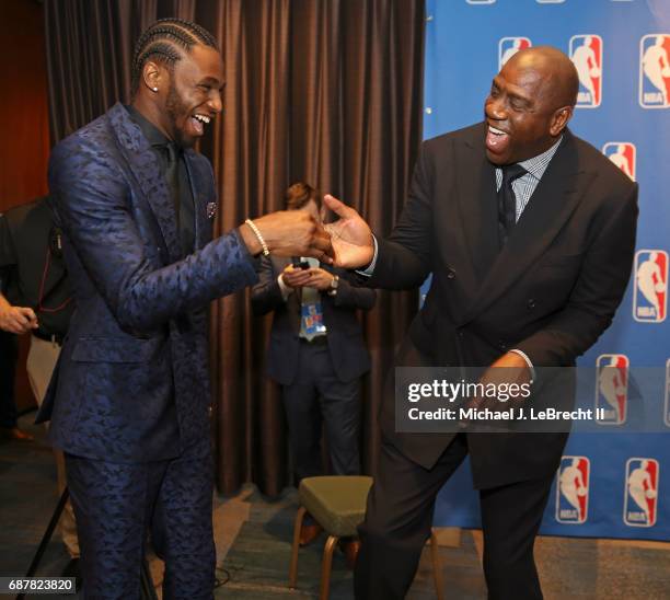 Magic Johnson of the Los Angeles Lakers talks with Andrew Wiggins of the Minnesota Timberwolves during the 2017 NBA Draft Lottery at the New York...