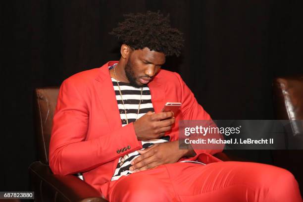 Joel Embiid of the Philadelphia 76ers looks on his phone during the 2017 NBA Draft Lottery at the New York Hilton in New York, New York. NOTE TO...