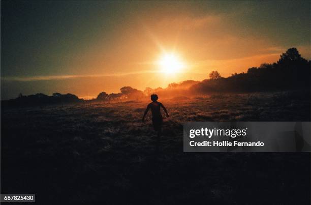 run at the sun - back lit runner stock pictures, royalty-free photos & images