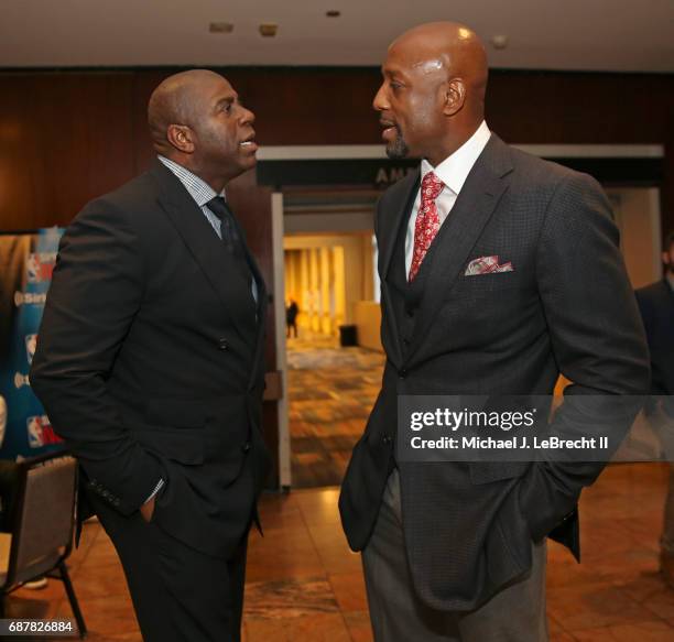 Alonzo Mourning of the Miami Heat and Magic Johnson of the Los Angeles Lakers talk during the 2017 NBA Draft Lottery at the New York Hilton in New...