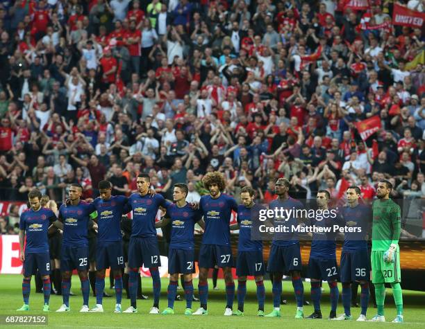 The Manchester United team take part in a minute's silence to honour the victims of the terrorist attack in Manchester on Monday ahead of the UEFA...