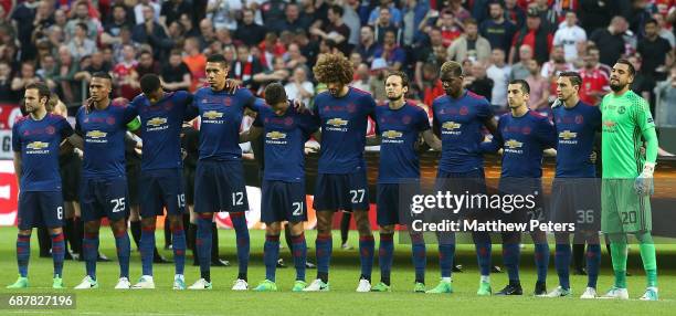 The Manchester United team take part in a minute's silence to honour the victims of the terrorist attack in Manchester on Monday ahead of the UEFA...