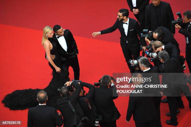 Dutch model Lara Stone and French fashion designer Olivier Rousteing pose as they arrive on May 24, 2017 for the screening of the film 'The Beguiled'...