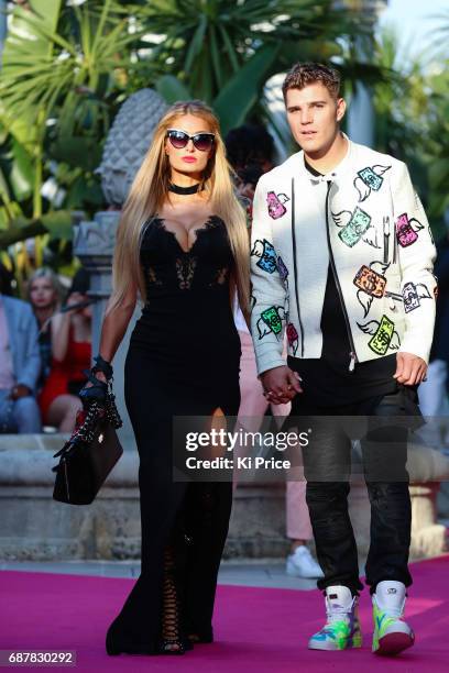 Paris Hilton with boyfriend Chris Zylka walks the runway at Philipp Plein Cruise Show 2018 during the 70th annual Cannes Film Festival on May 24,...