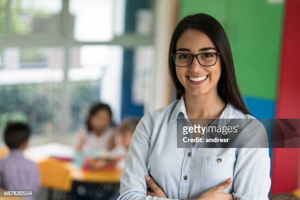 porträt von glücklich lateinamerikanischen lehrer an der schule - teacher stock-fotos und bilder