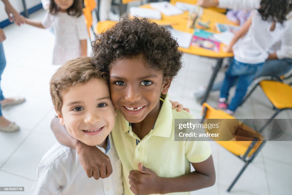 Portrait of two happy multi-ethnic friends at school