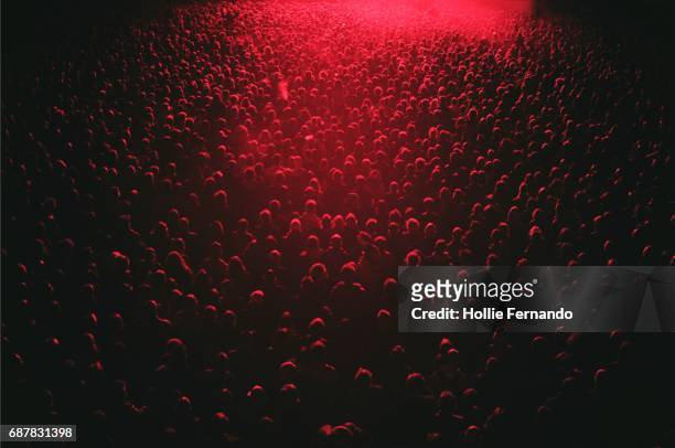 red lit festival crowd - menschenmenge stock-fotos und bilder