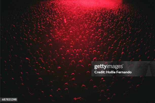 red lit festival crowd - in concert fotografías e imágenes de stock