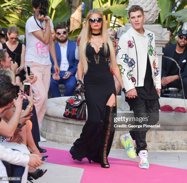 Paris Hilton and Chris Zylka attends the/walks the runway at the Philipp Plein Cruise Show 2018 during the 70th annual Cannes Film Festival at on May...